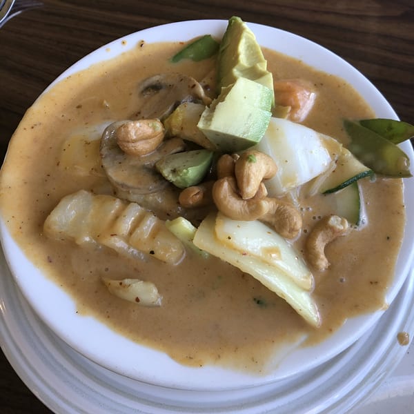 Spikey Ty's Asian curry dish with avocado, cashews, mushrooms, and vegetables in a rich sauce.